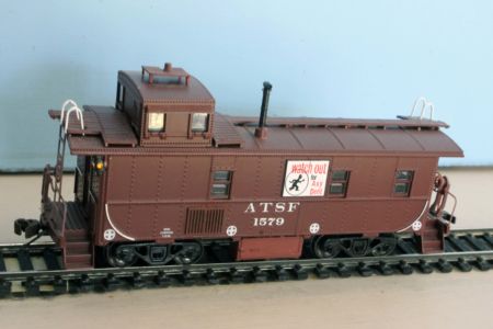 ATSF Caboose #1579. This model is made from an Athearn "ready to roll" Santa Fe style way car with added steel battery box, marker lights, and radio ground plane and antenna. Model and photo by Bob Walz. ATSF Caboose #1579 (model)