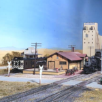 This is the depot at Follett, Texas on the Shattuck Branch of Bill Van der Meer's Sweetwater & Orient (#1). Ten wheeler #472 is bringing up a mixed freight while M0-117 motor car idles on the house track. Model of depot at Follett, TX